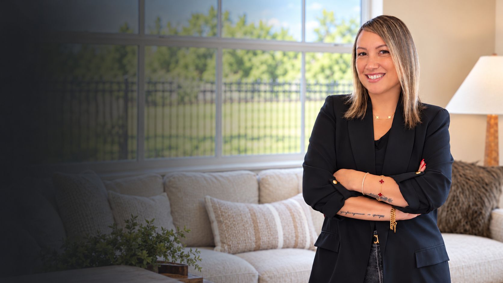 Jenn Pagsolingan, an East Bay and Tri-Valley REALTOR®, smiling with her arms crossed in a bright living room