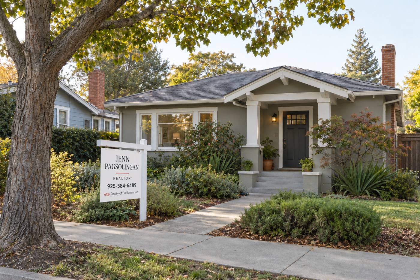 Craftsman-style home with a front walkway, mature trees, and a REALTOR sign in the front yard